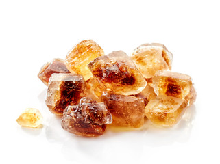 Brown caramelized sugar cubes on a white background