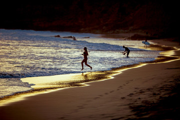 Fototapeta na wymiar Girl running on a beach