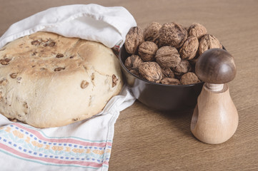 Bread, nutcracker and walnuts in a wooden table