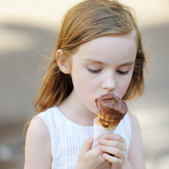 Adorable little girl eating ice-cream