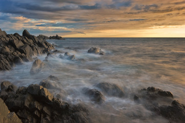 Sea coast after the storm at sunset.