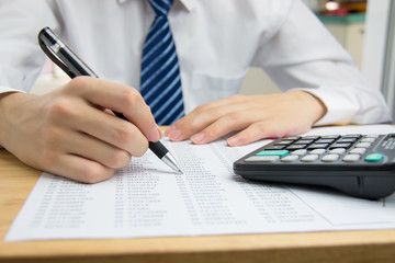Fototapeta na wymiar Businessman calculating the financial statements