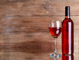 Red wine on table on wooden background