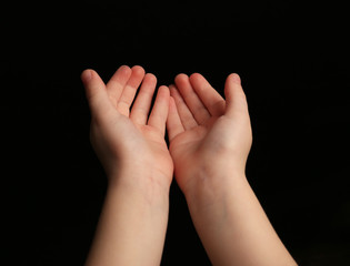 Fototapeta premium Child hands on black background