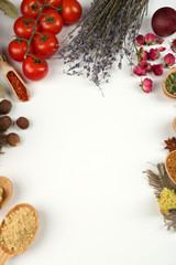 Different spices and herbs in wooden spoons isolated on white