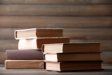 Stack of books on wooden planks background