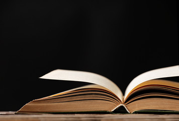 Open book with light over dark background