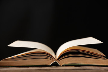 Open book with light over dark background