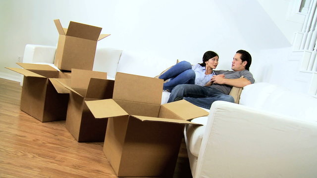 Ethnic Couple Relaxing White Couch New Home 