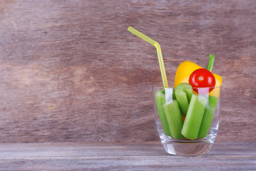 Sticks of celery with sweet pepper and cherry tomato in glass