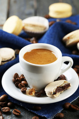 Gentle colorful macaroons and  coffee in mug