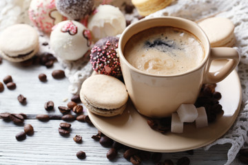 Gentle colorful macaroons and  coffee in mug