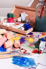 Professional art materials on color wooden background