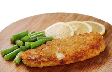 Breaded fried fish fillet and potatoes with asparagus and