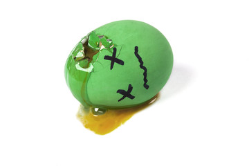 Dead green egg with broken shell