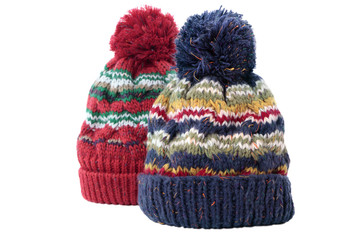 Two chunky knit warm winter bobble knit hats ski clothing isolated white background photo