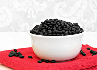 Fototapeta na wymiar Black turtle beans in a white bowl.