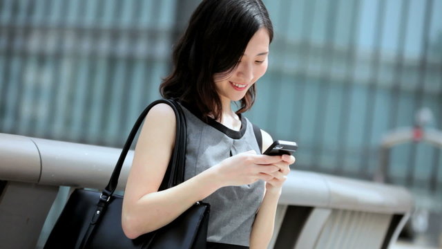 Young Ethnic Asian Japanese Businesswoman City Downtown Smart Phone Device