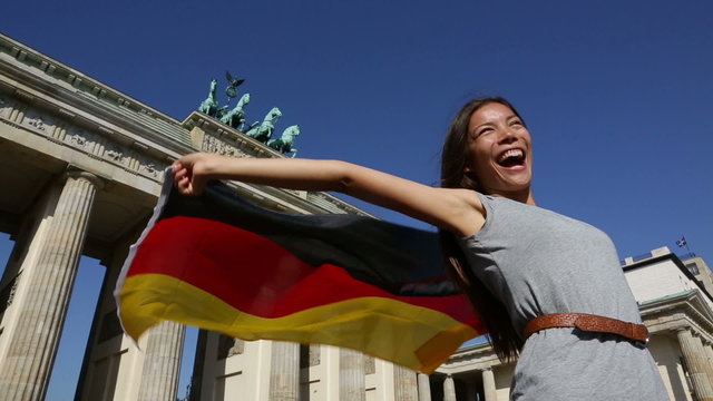 German flag woman joy at Berlin Brandenburger Tor