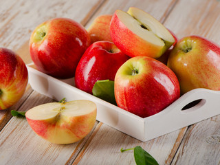 Fresh apples  in white box on  wooden table