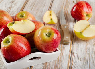 Ripe apples  in a  wooden white box .