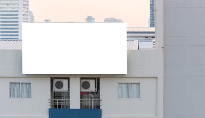 blank billboard on building in city view background