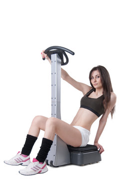 Young athletic woman with massage machine
