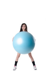 Young athletic woman with blue exercise ball