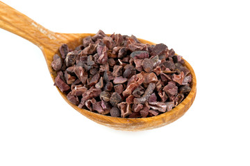 cocoa nibs in a wooden spoon