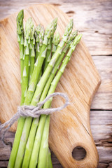 Asparagus on the wooden background.