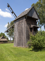 Old wooden windmill on background of blue sky © wjarek