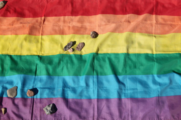 Jewish stones lie on the rainbow flag in the Buchenwald Camp
