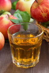 apple cider or juice in a glass, vertical, selective focus