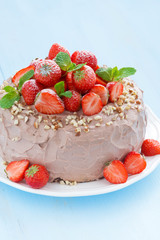 chocolate cake with fresh strawberries on a blue background