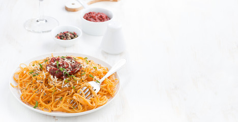 spaghetti with tomato sauce and parmesan on white wooden table