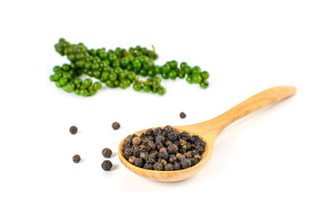 Black pepper in wooden spoon