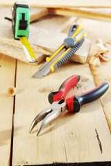 Pliers and a cutter lie on the workbench