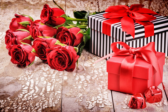 Valentine's setting with bouquet of red roses and presents