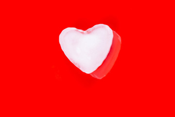 Valentines greeting card with ice heart on red background