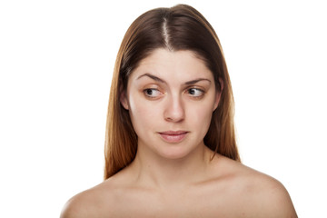 Fototapeta premium Pensive young woman without make up on white background