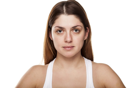 young woman without make-up on white background