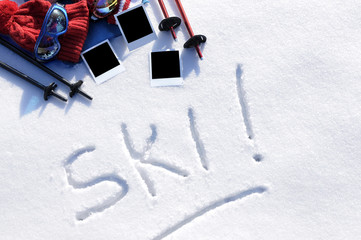 Ski word written in snow with equipment and clothing polaroid style prints skiing vacation holiday concept photo