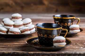 Cup of coffee and chocolate macaroons