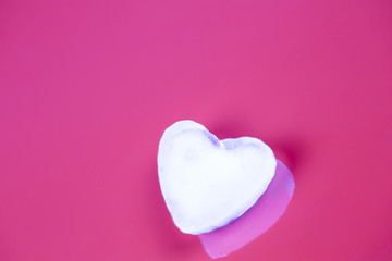 Valentines greeting card with ice heart on pink background