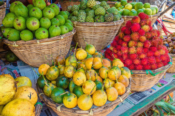 Baskets with tropical fruit: rambutan, passion fruit