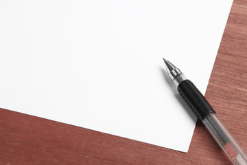 White Paper and Pen On Desk