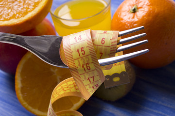 Fruits with measuring tape with wood background