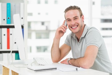 Fototapeta premium Smiling businessman making a call