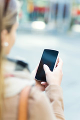 Woman using mobile phone outdoors