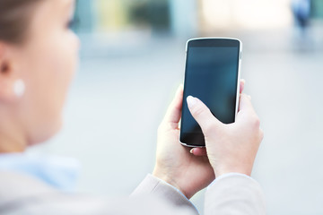 Woman using mobile phone outdoors